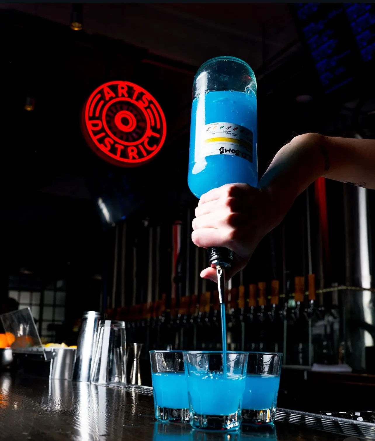 A bartender pouring a shot