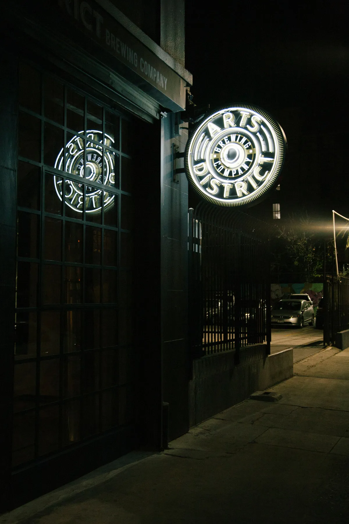 The building at night with the badge sign lit