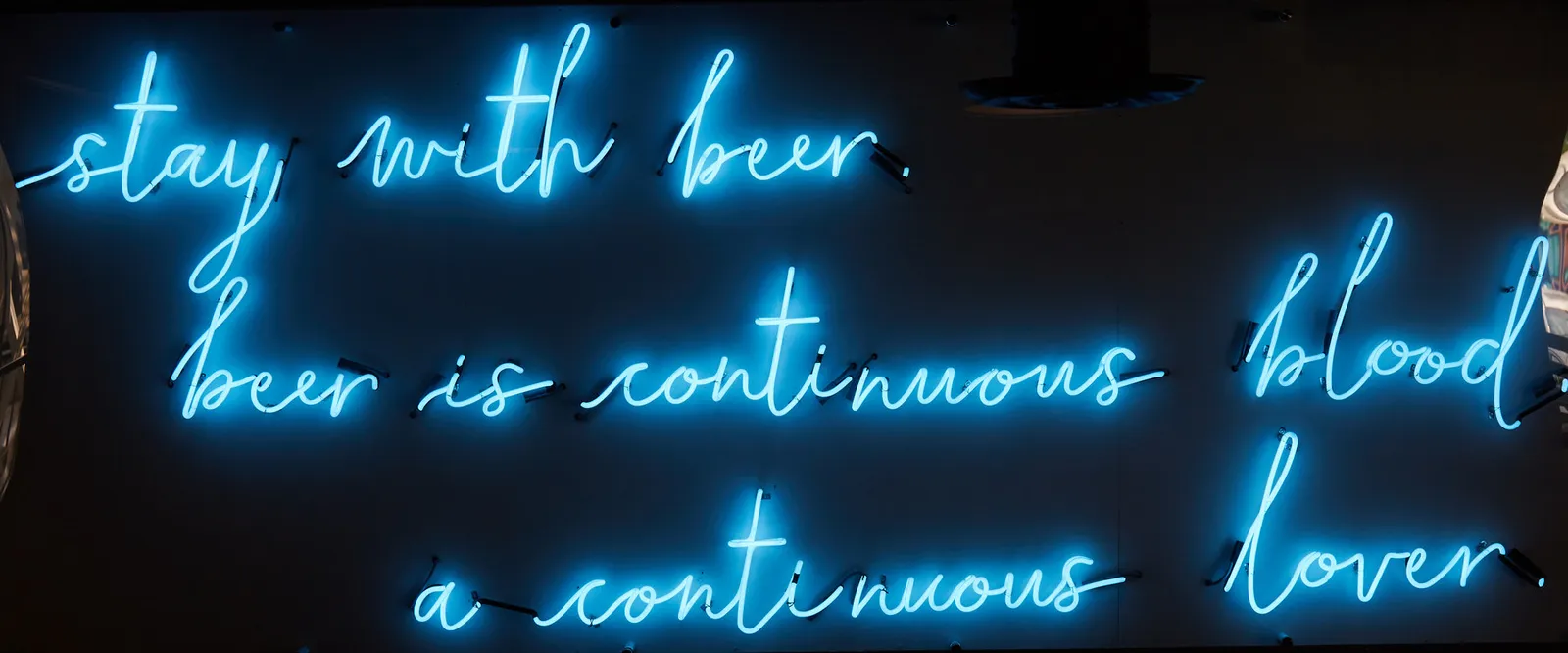 The blue neon beer quote on the wall