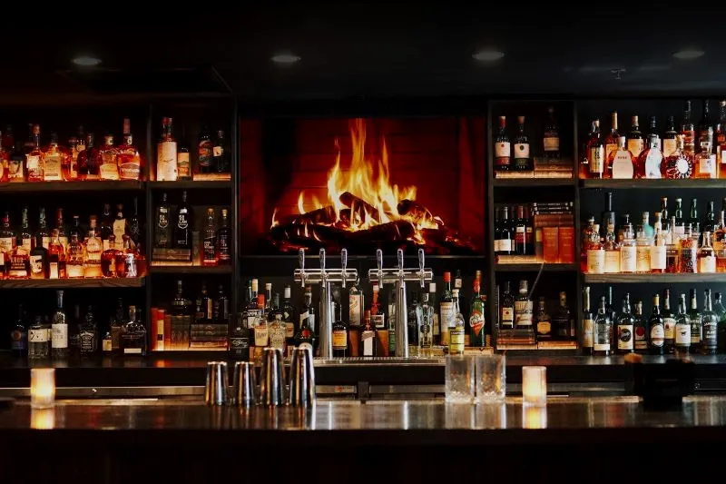The Study, a dim cocktail room with a backlit bar