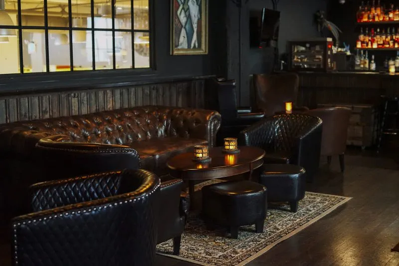 A corner booth under a small lamp