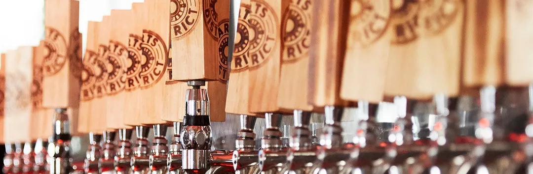A row of tap handles with the ADBC badge